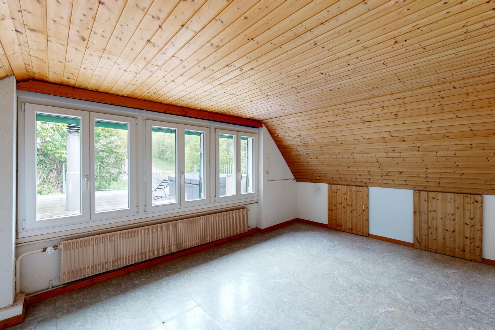empty room featuring radiator, a vaulted wooden ceiling, tile patterned floors, and wooden walls