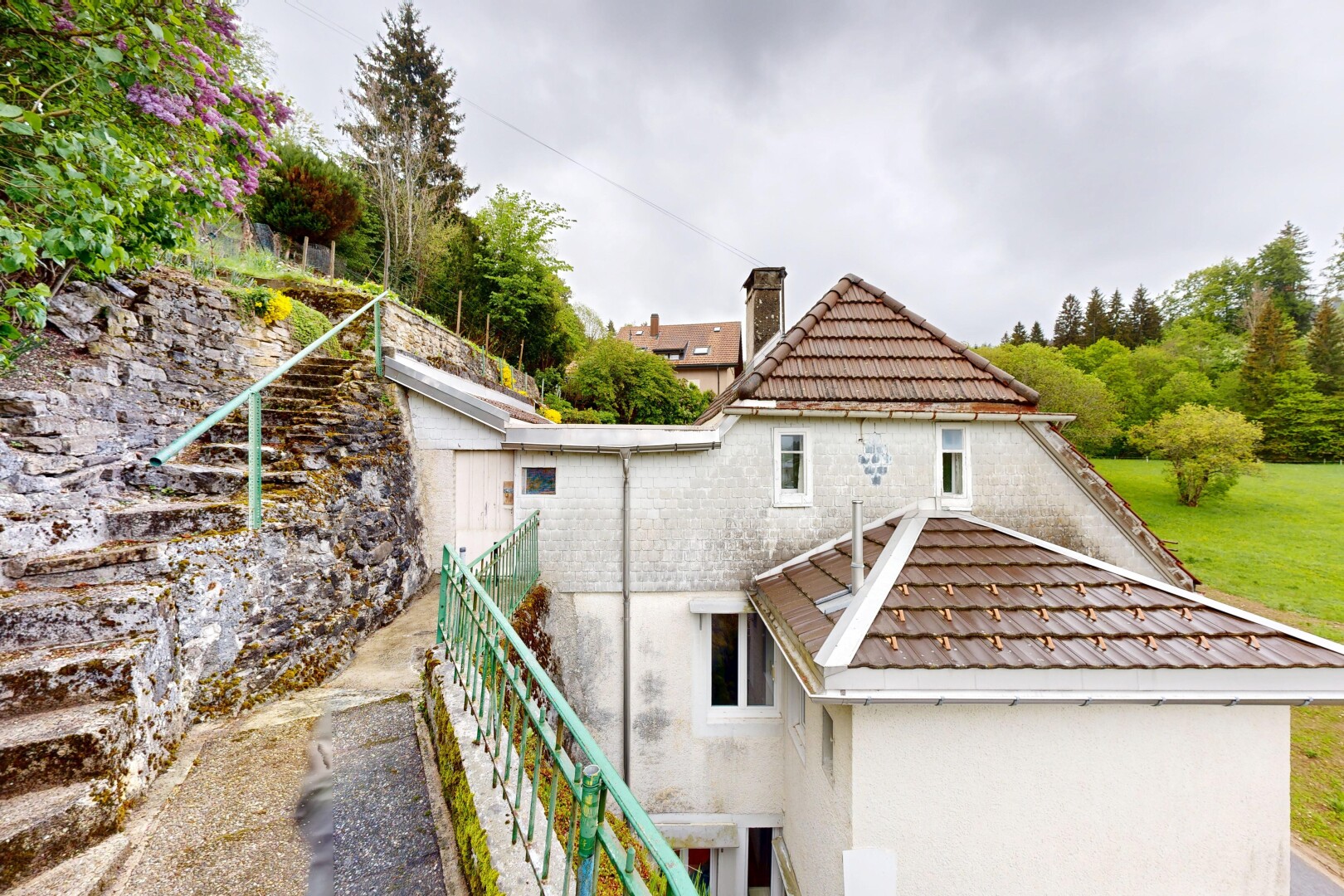 outdoor house featuring stucco siding and a chimney