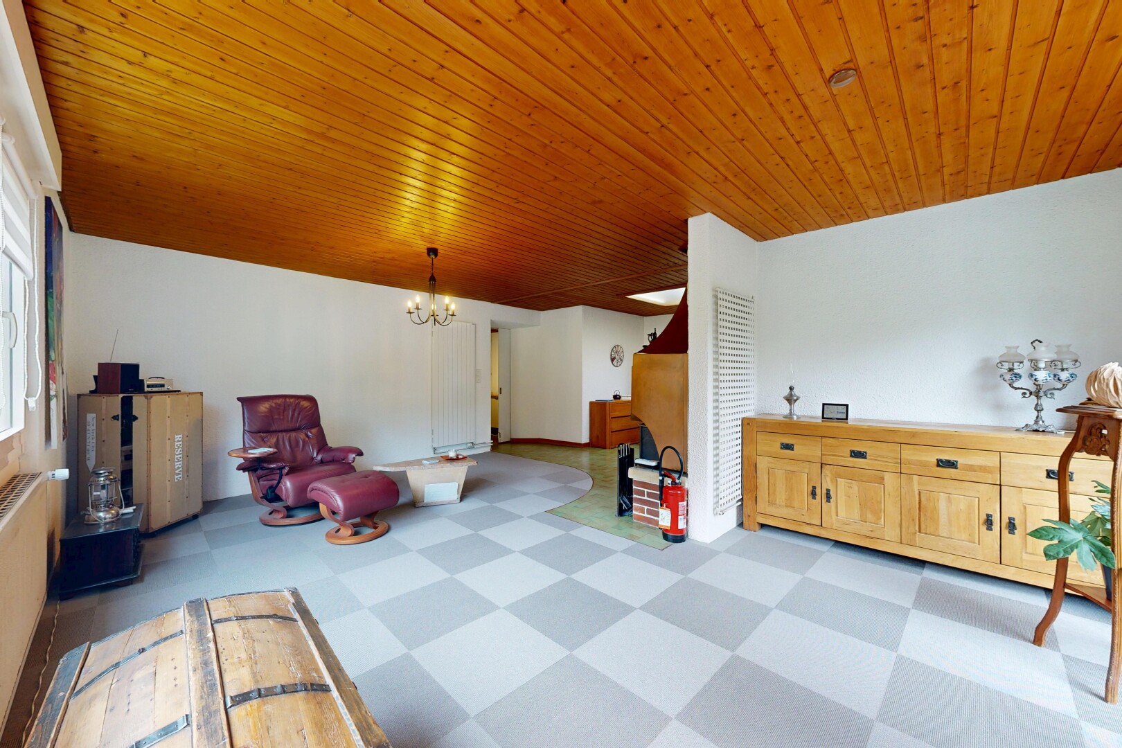 living area featuring a chandelier, light floors, and wooden ceiling