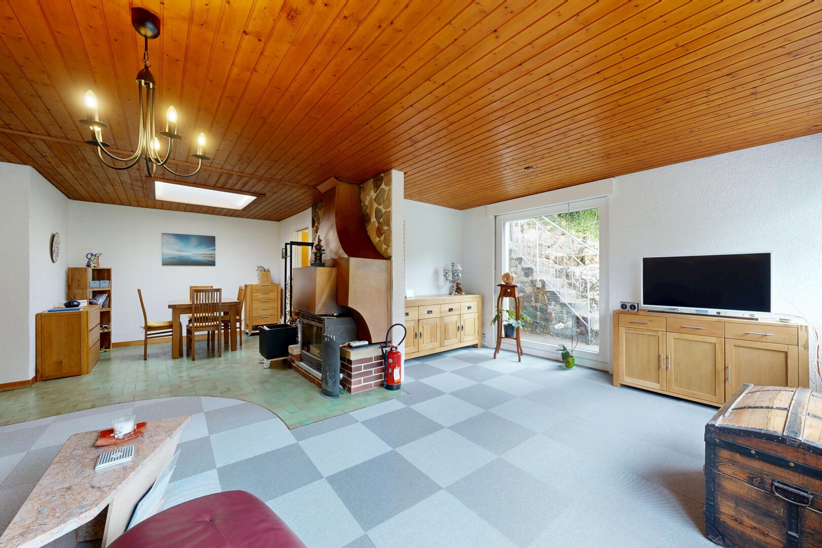living / dining area with light floors, wood ceiling, and a chandelier