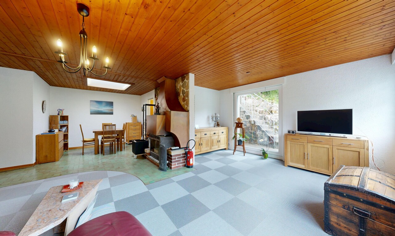 living / dining area with light floors, wood ceiling, and a chandelier