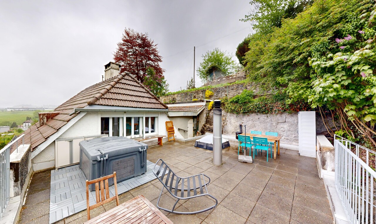 terrace with outdoor dining area, a hot tub, and a patio