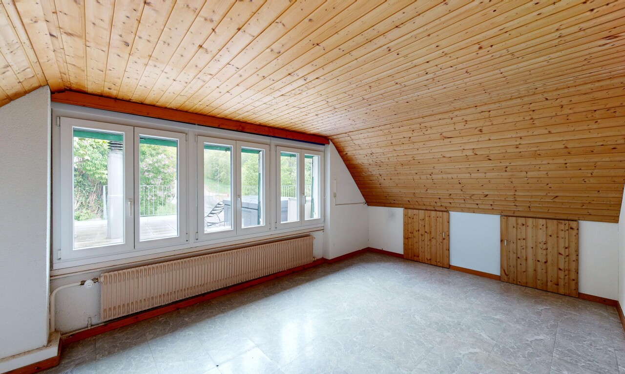 empty room featuring radiator, a vaulted wooden ceiling, tile patterned floors, and wooden walls