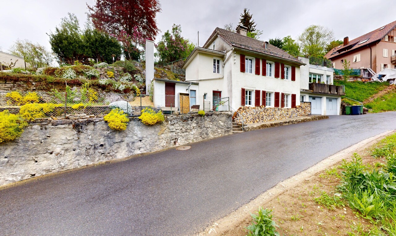 view of property with stucco siding and a chimney