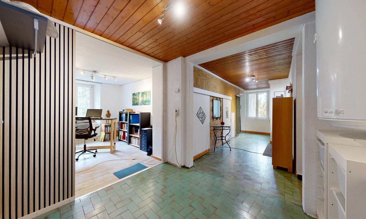corridor featuring wooden ceiling, an office area, and rail lighting