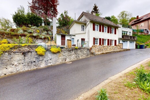 view of property with stucco siding and a chimney