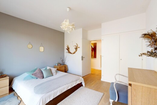 chambre avec wood finish floor, sol en finition bois, drywall, cloison sèche, et lustre remarquable