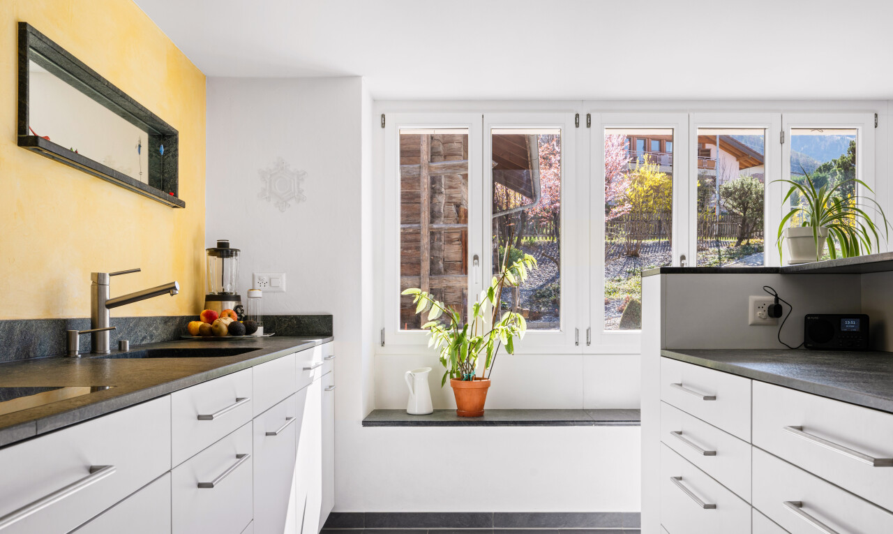 kitchen featuring dark countertops, white cabinets, and dark tile patterned flooring