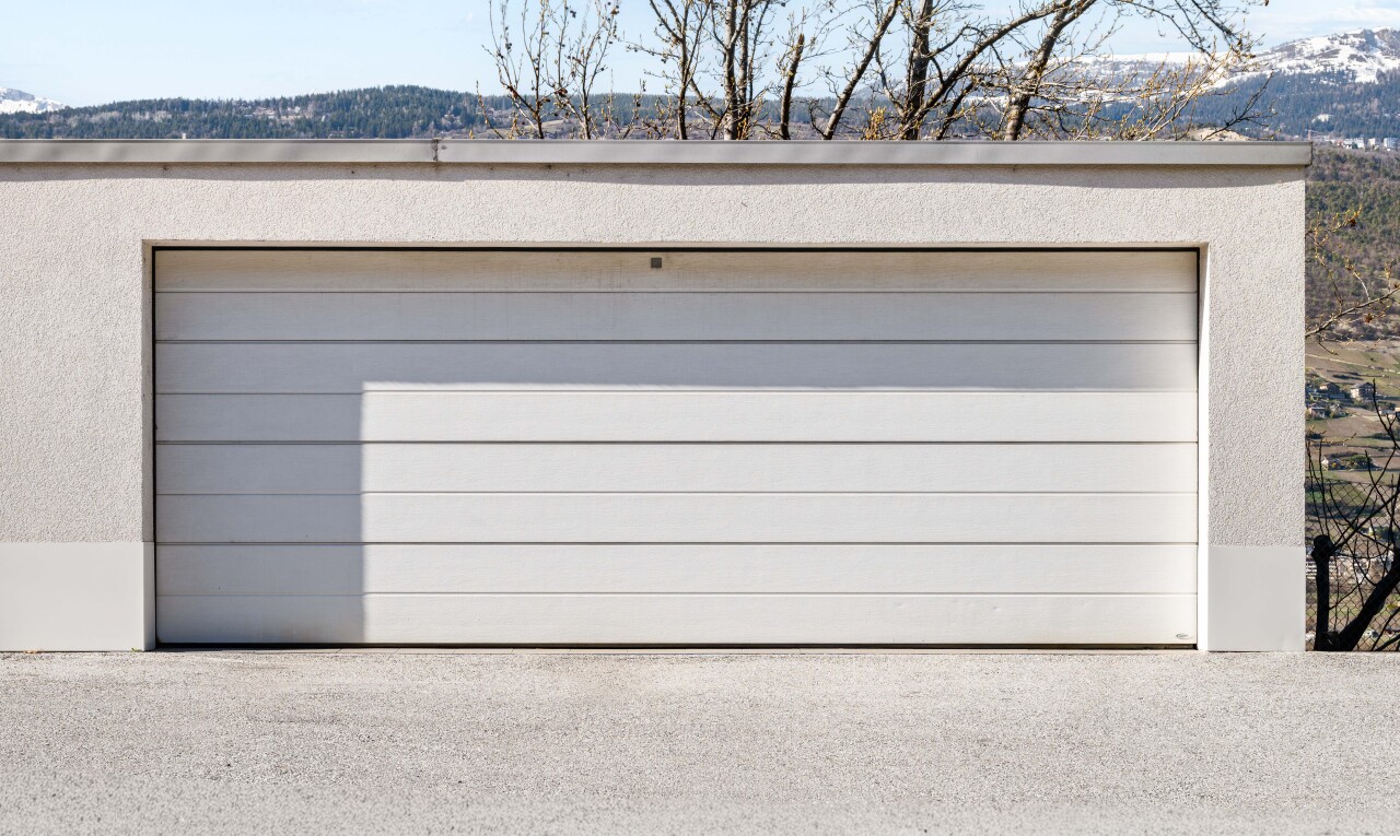 view of property with a garage, an outdoor structure, and a mountain view