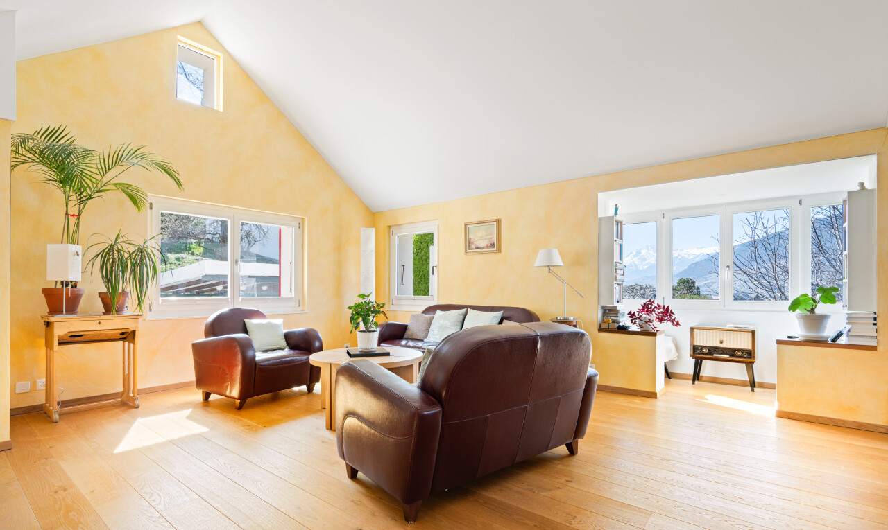 living room featuring a high ceiling and light wood-type flooring