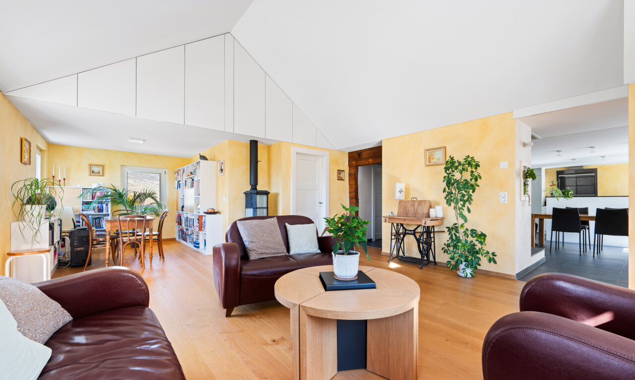 living room with wood finished floors and a high ceiling