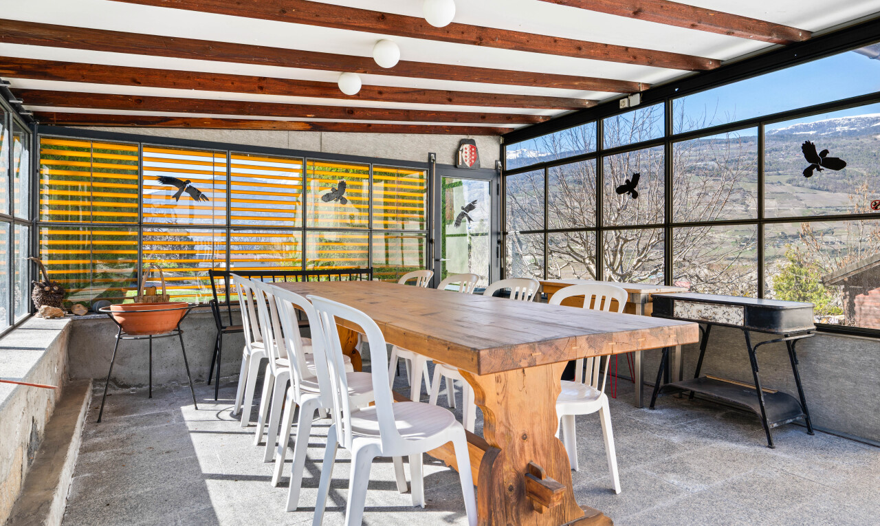 patio / terrace with outdoor dining space and a sunroom