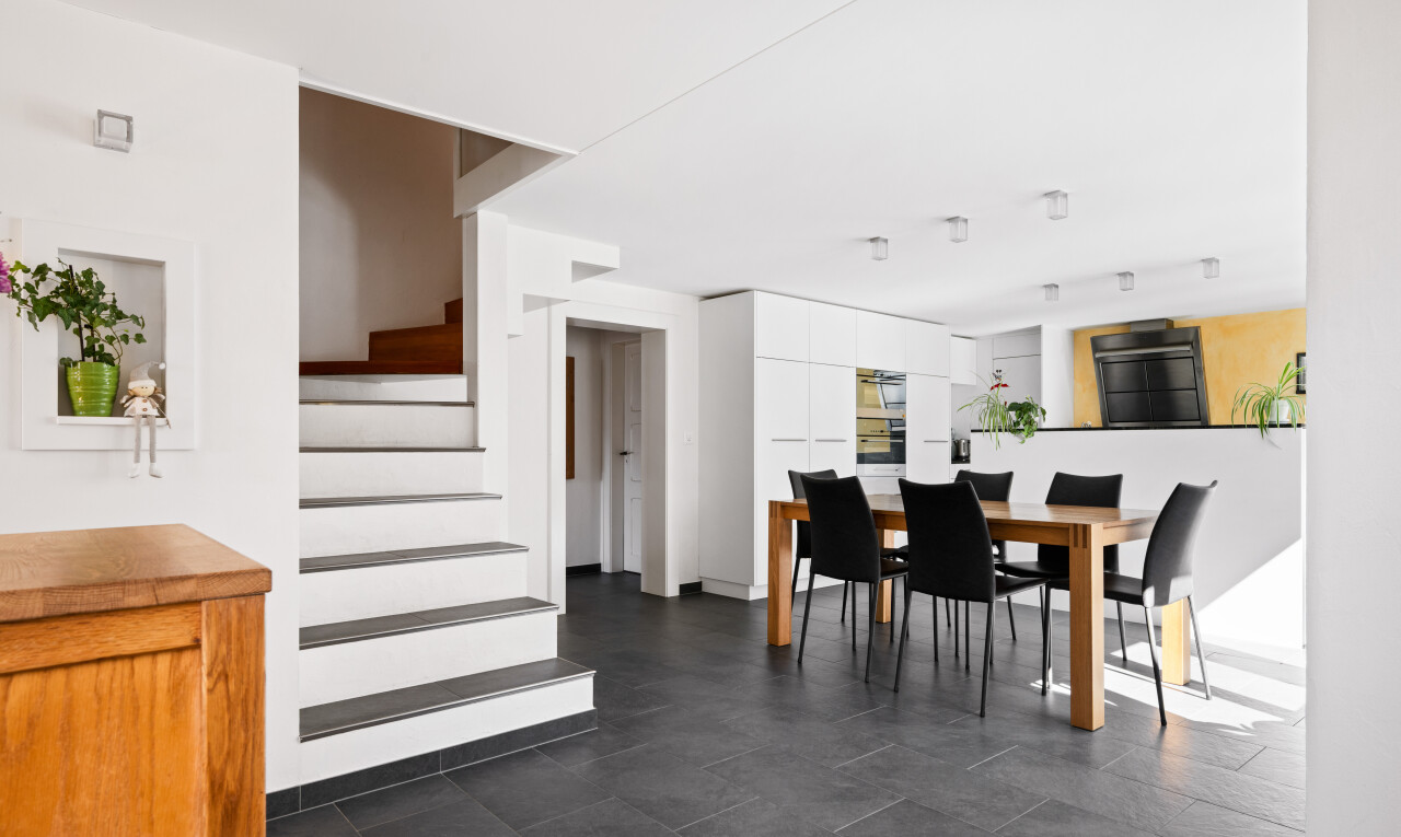 dining space featuring stairs