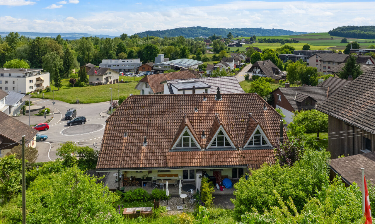 outdoor house featuring a tiled roof and a mountain view