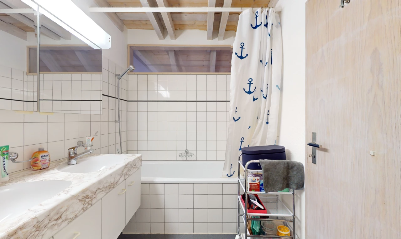 bathroom with vanity with extensive cabinet space, tile walls, and shower / bath combo