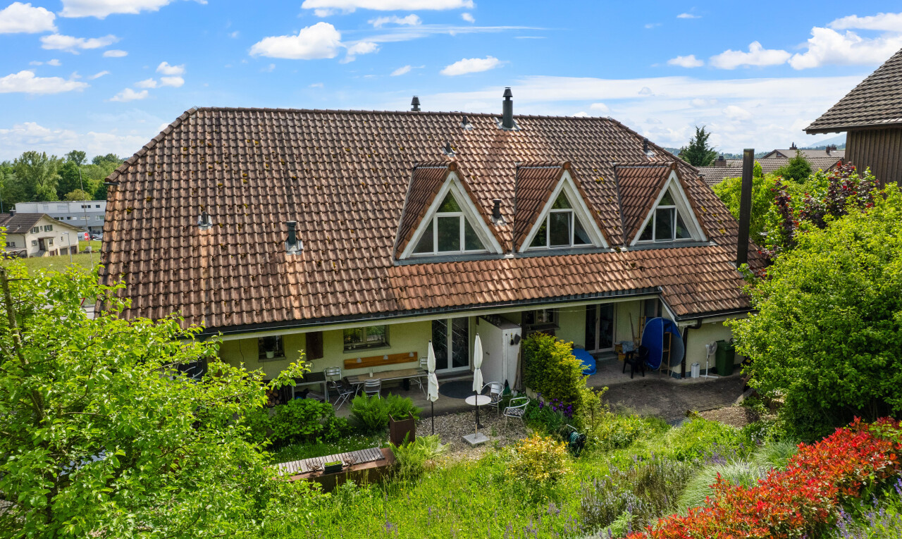 view of home featuring a tile roof, a patio area, and stucco siding