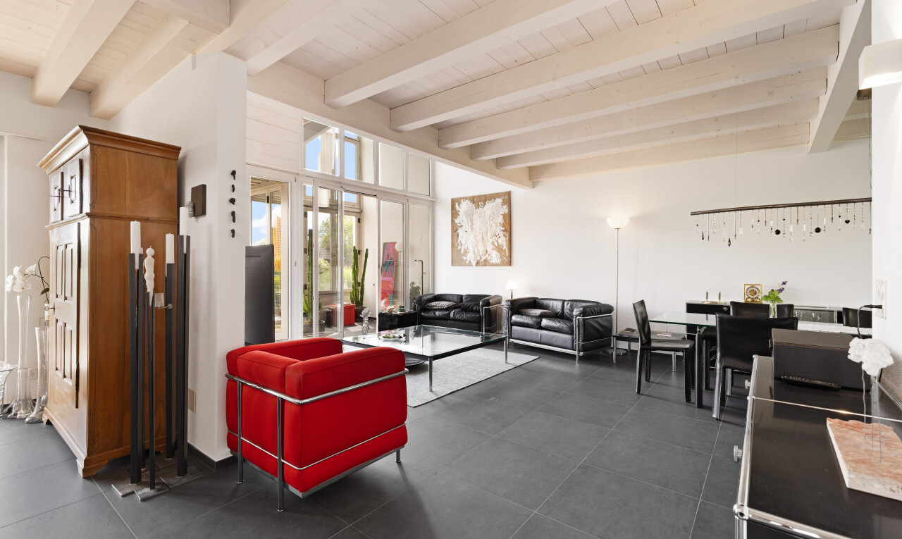 living area with a wooden ceiling with exposed beams
