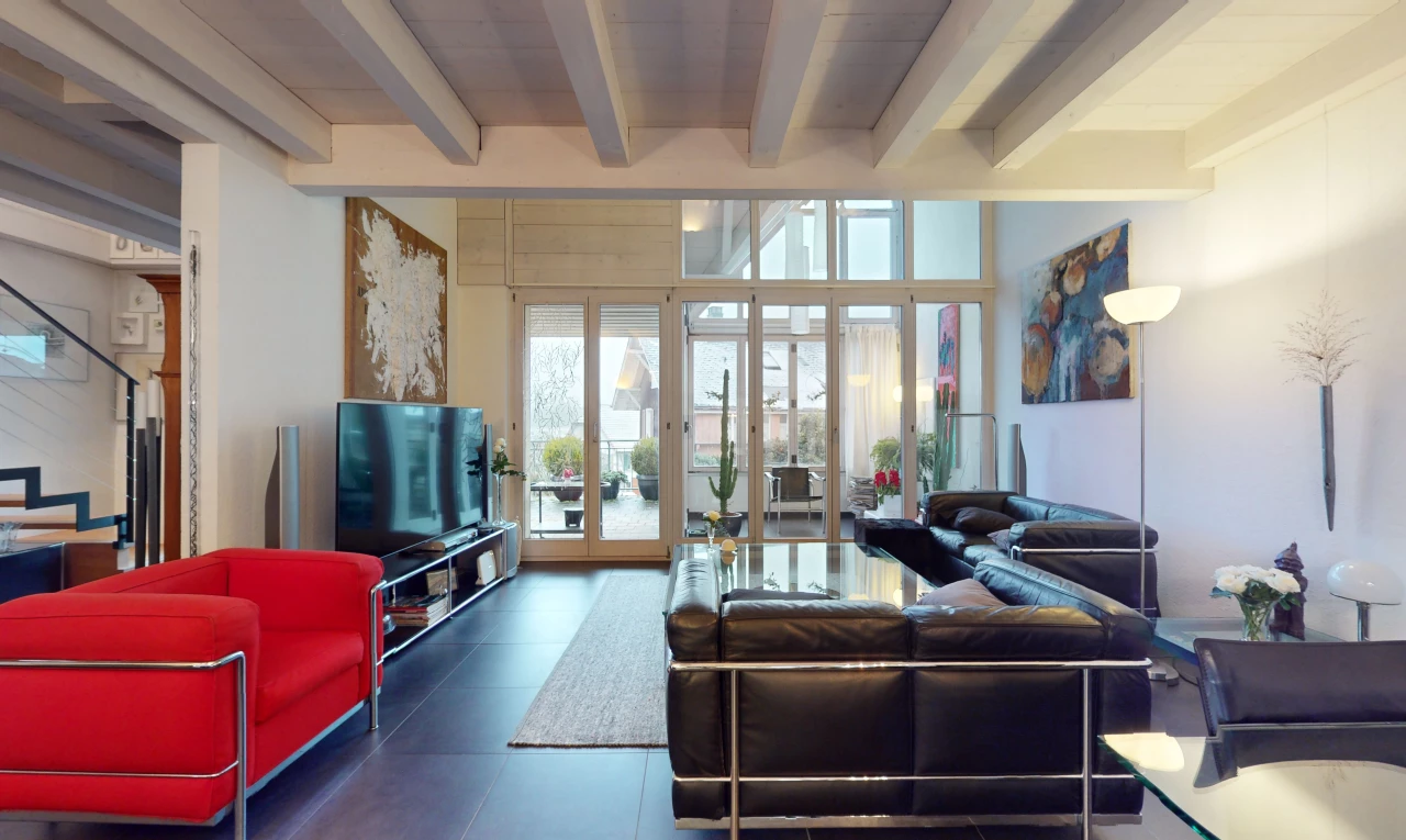 tiled living room with beamed ceiling and french doors
