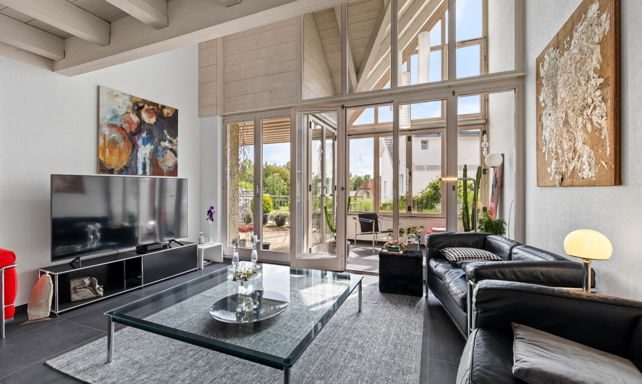 living room featuring beam ceiling and high vaulted ceiling
