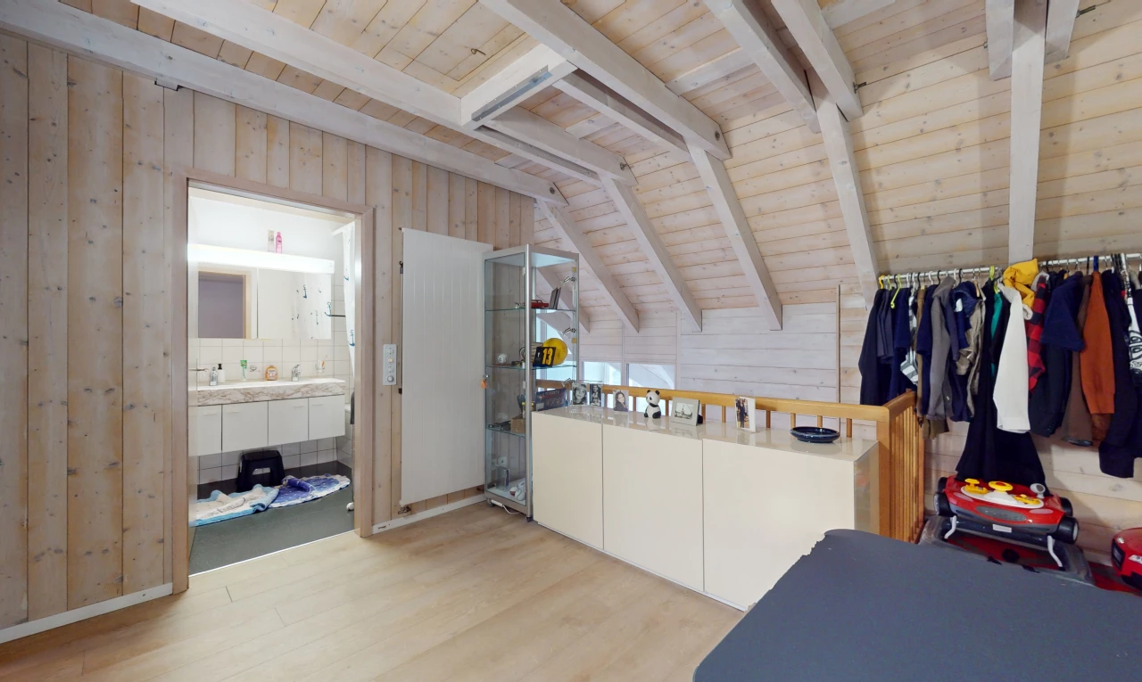 interior space with wooden ceiling, wood walls, ensuite bath, light hardwood / wood-style flooring, and vaulted ceiling with beams