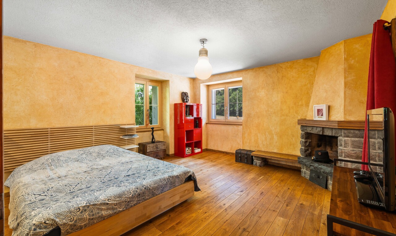 chambre avec télévision, inside property, sol en finition bois, wood finish floor, et lumière naturelle