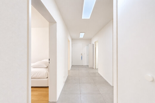 corridor featuring light tile patterned floors