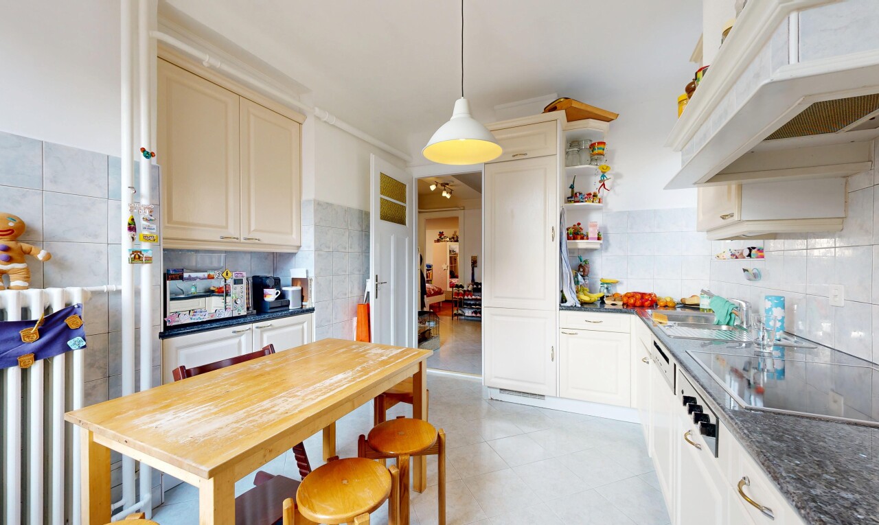 cuisine avec dark countertops, plans de travail, hotte, raised cabinets, et armoires élevées