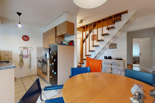 küche mit küchenrückwand beim herd, fliesenboden, waschbecken, und pendelleuchte