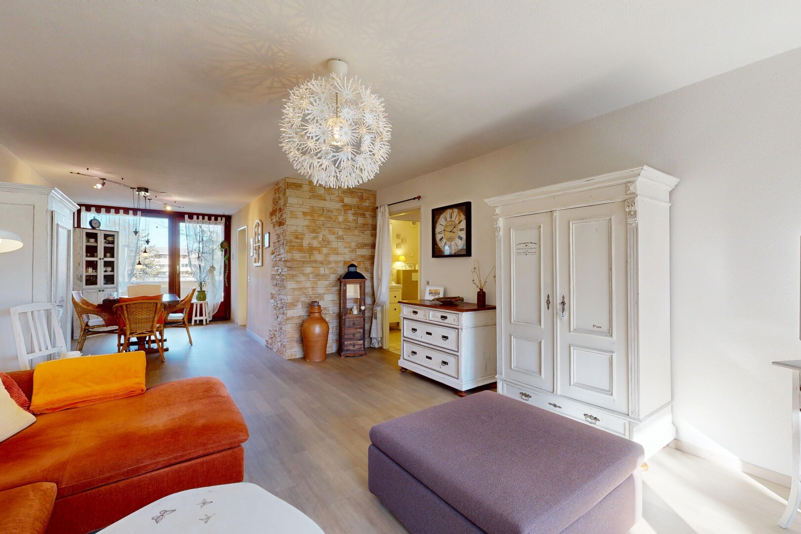 living room featuring a chandelier and light wood-style floors