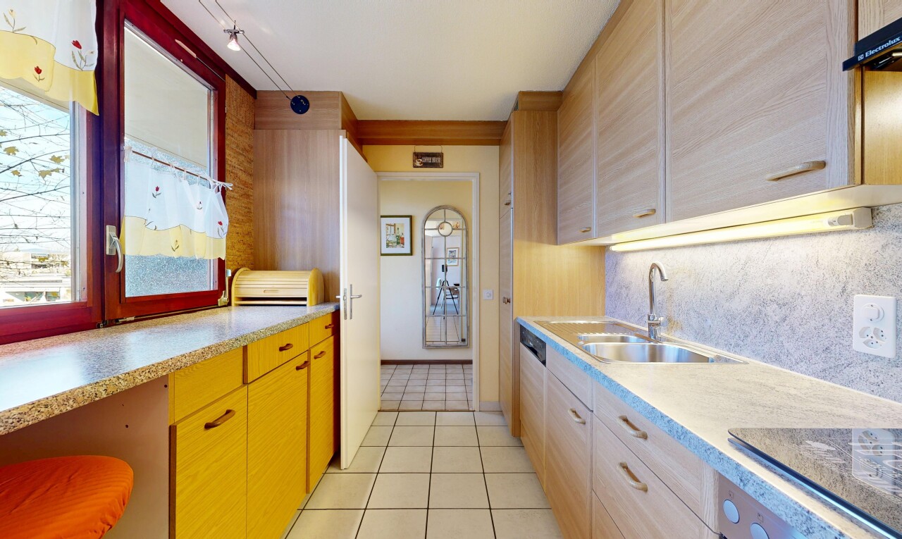 kitchen featuring light tile patterned floors, black electric stovetop, light stone countertops, and oven