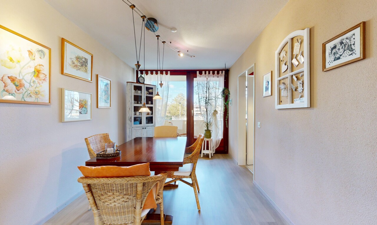 dining space with light wood-style flooring and baseboards