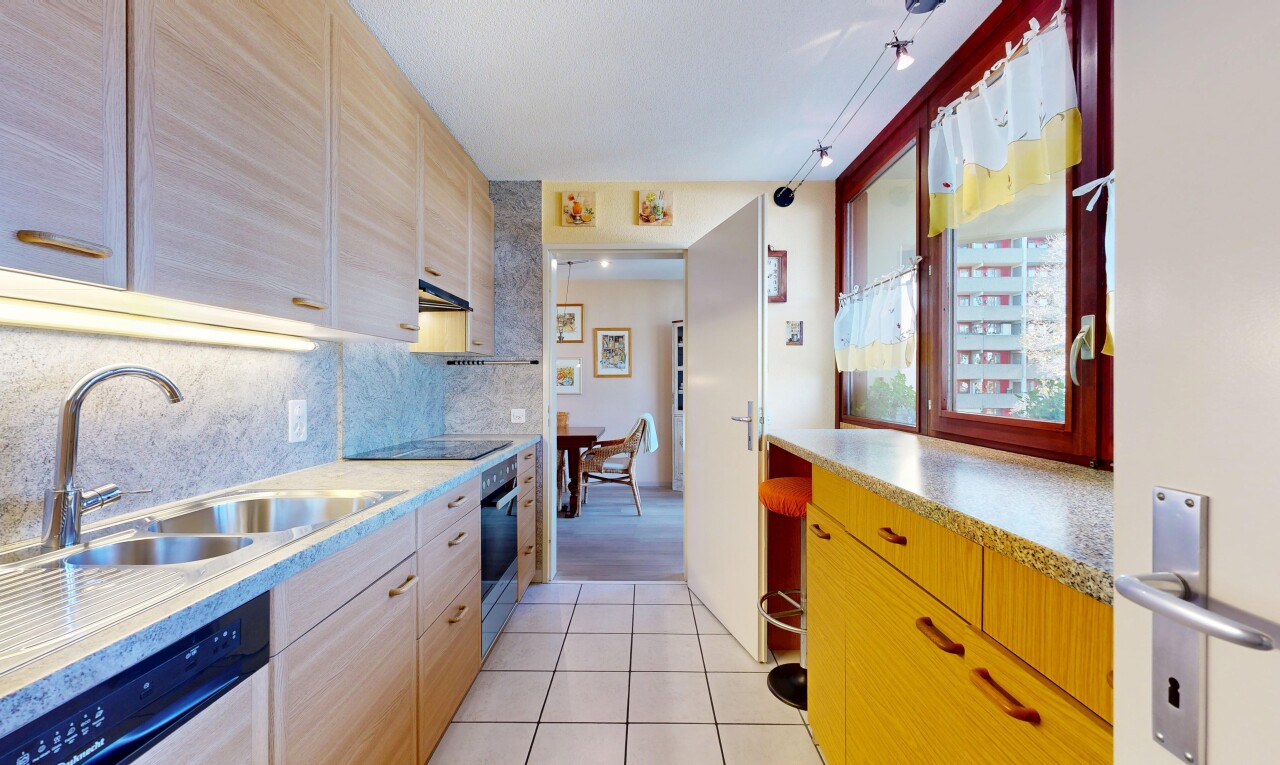 kitchen featuring light tile patterned flooring, backsplash, dishwasher, oven, and light brown cabinets