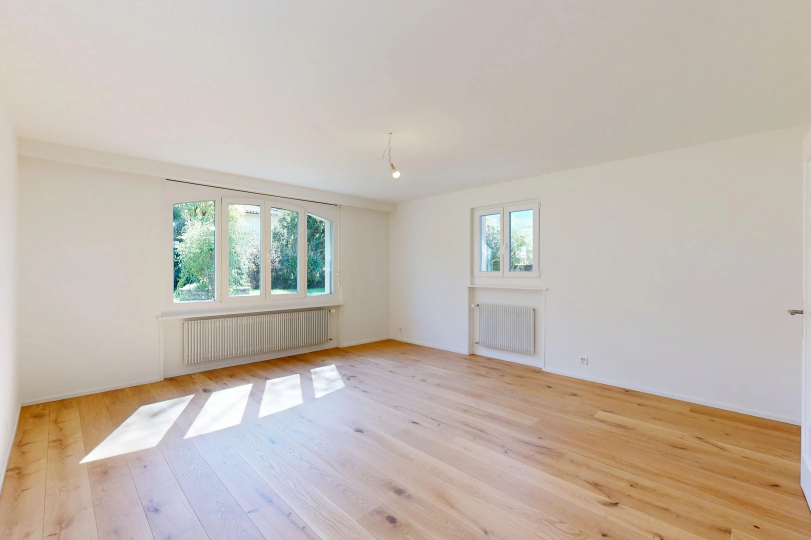 pièce vide avec radiateur, drywall, cloison sèche, wood finish floor, et inside property