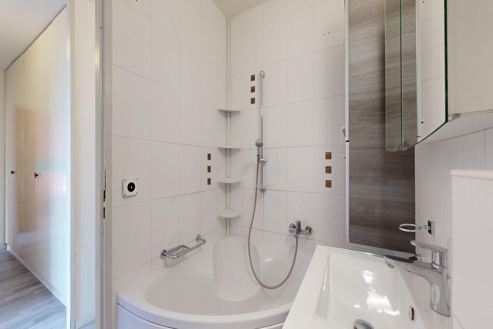 bathroom with tile walls, bathing tub / shower combination, and vanity