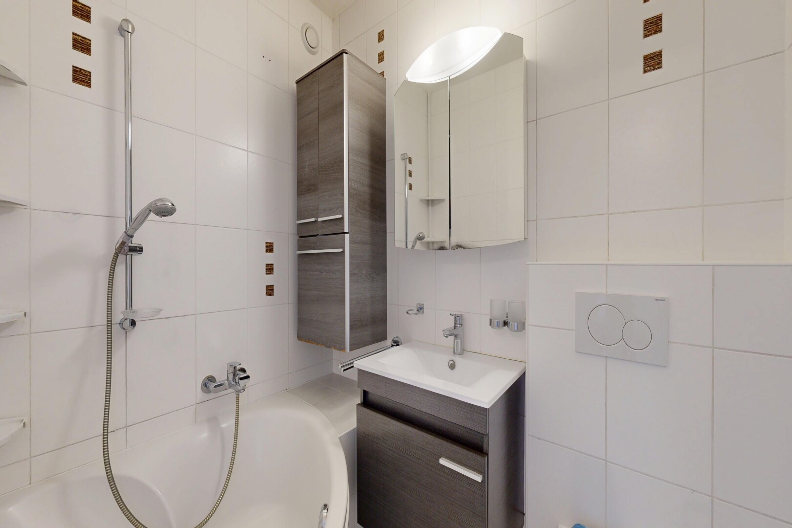 full bath featuring tile walls, vanity, and tub / shower combination