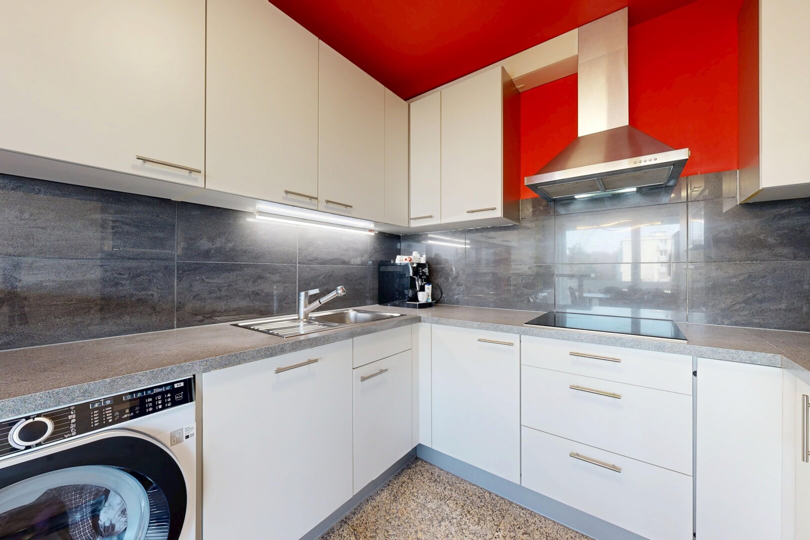 kitchen with washer / clothes dryer, decorative backsplash, white cabinetry, black electric cooktop, and light countertops
