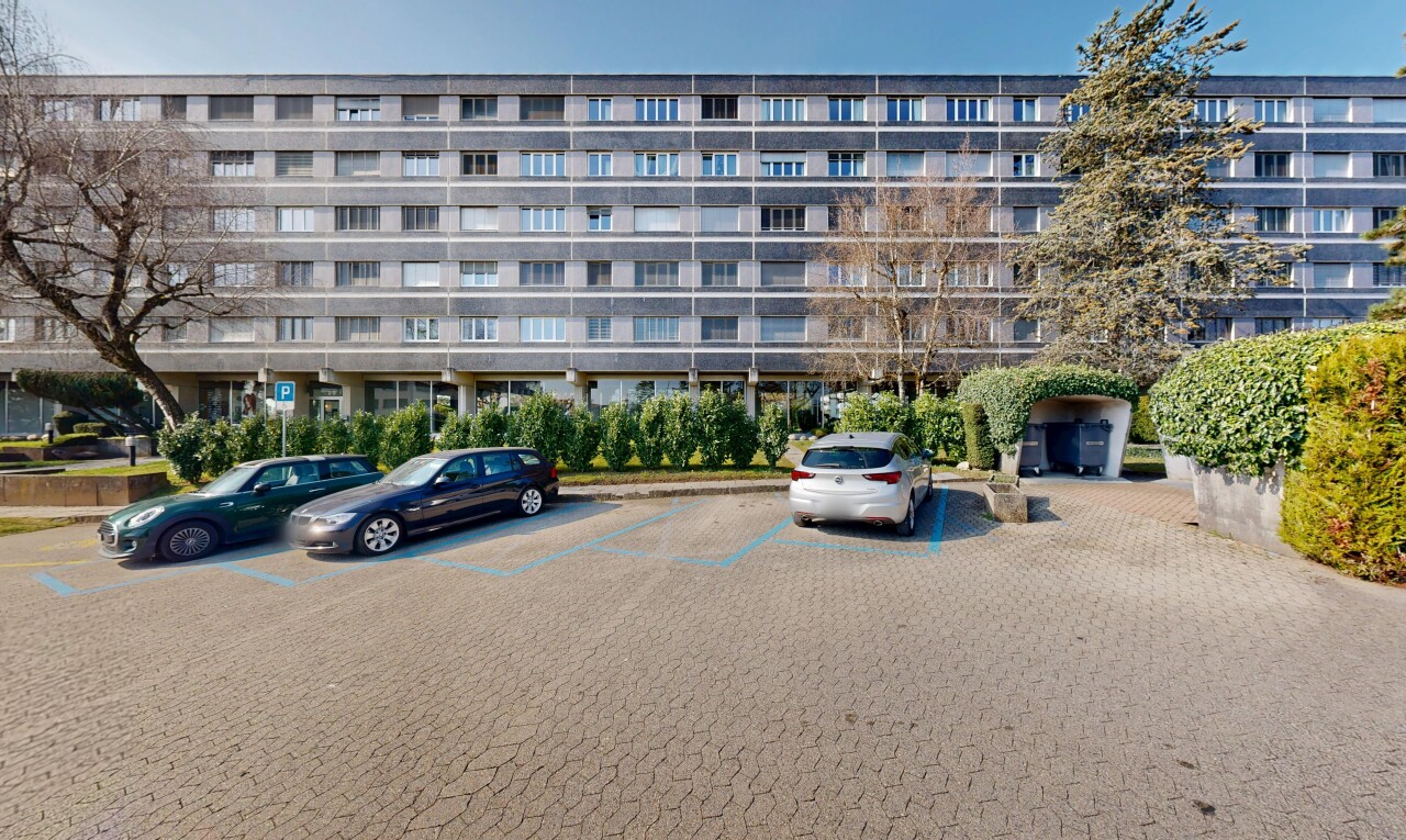 view of apartment building / complex featuring uncovered parking