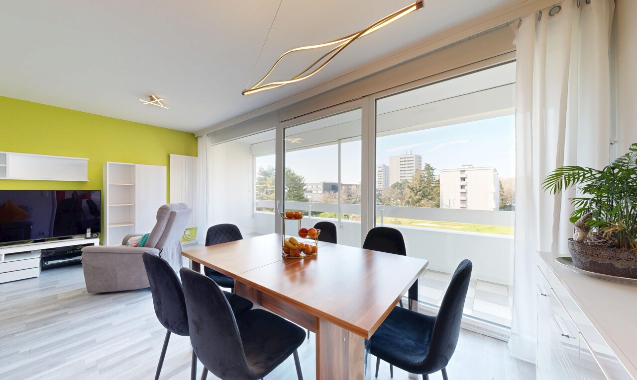 dining room featuring light wood finished floors and a view of city