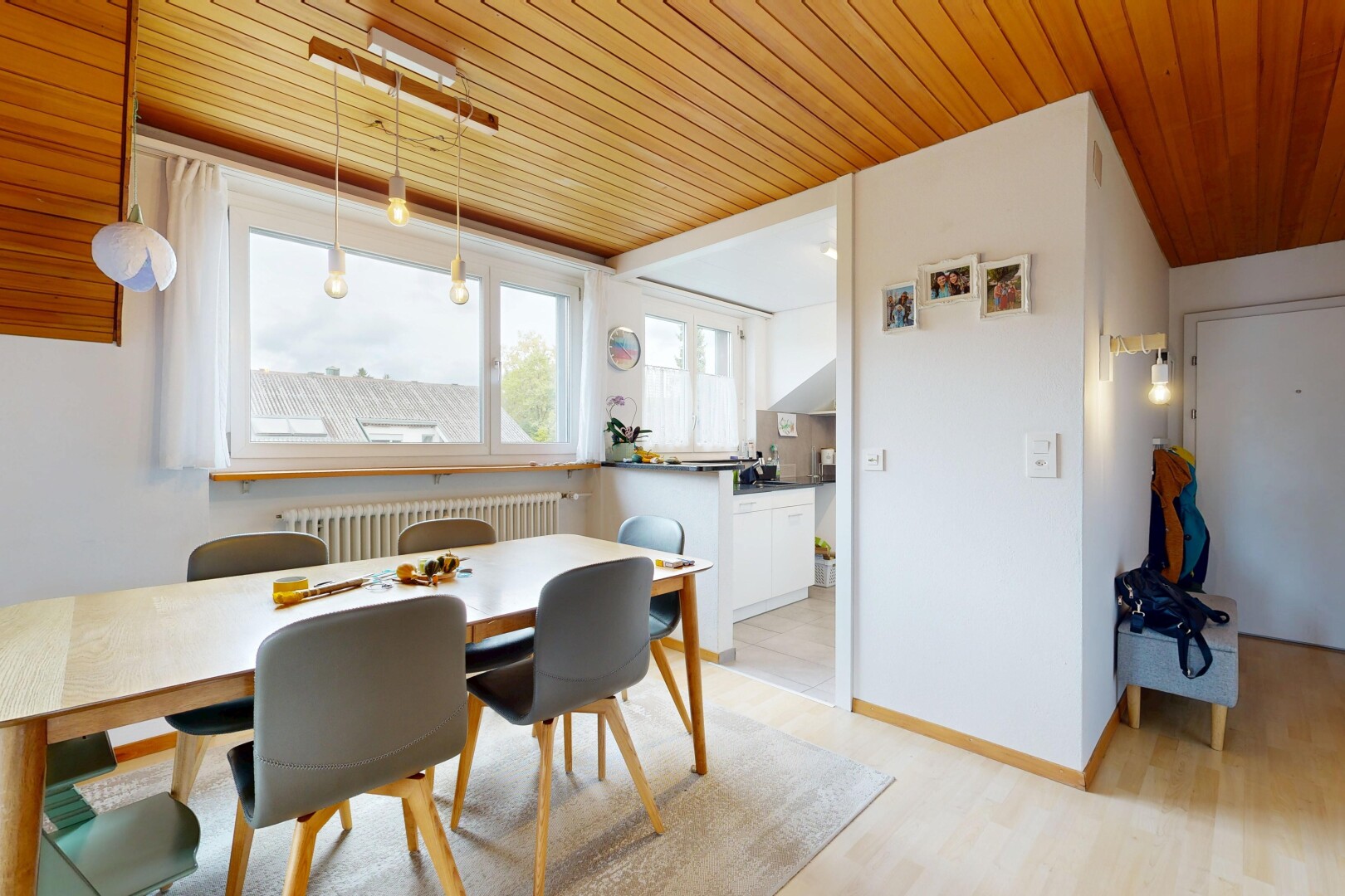 dining room featuring wood ceiling, radiator heating unit, and light wood-style flooring