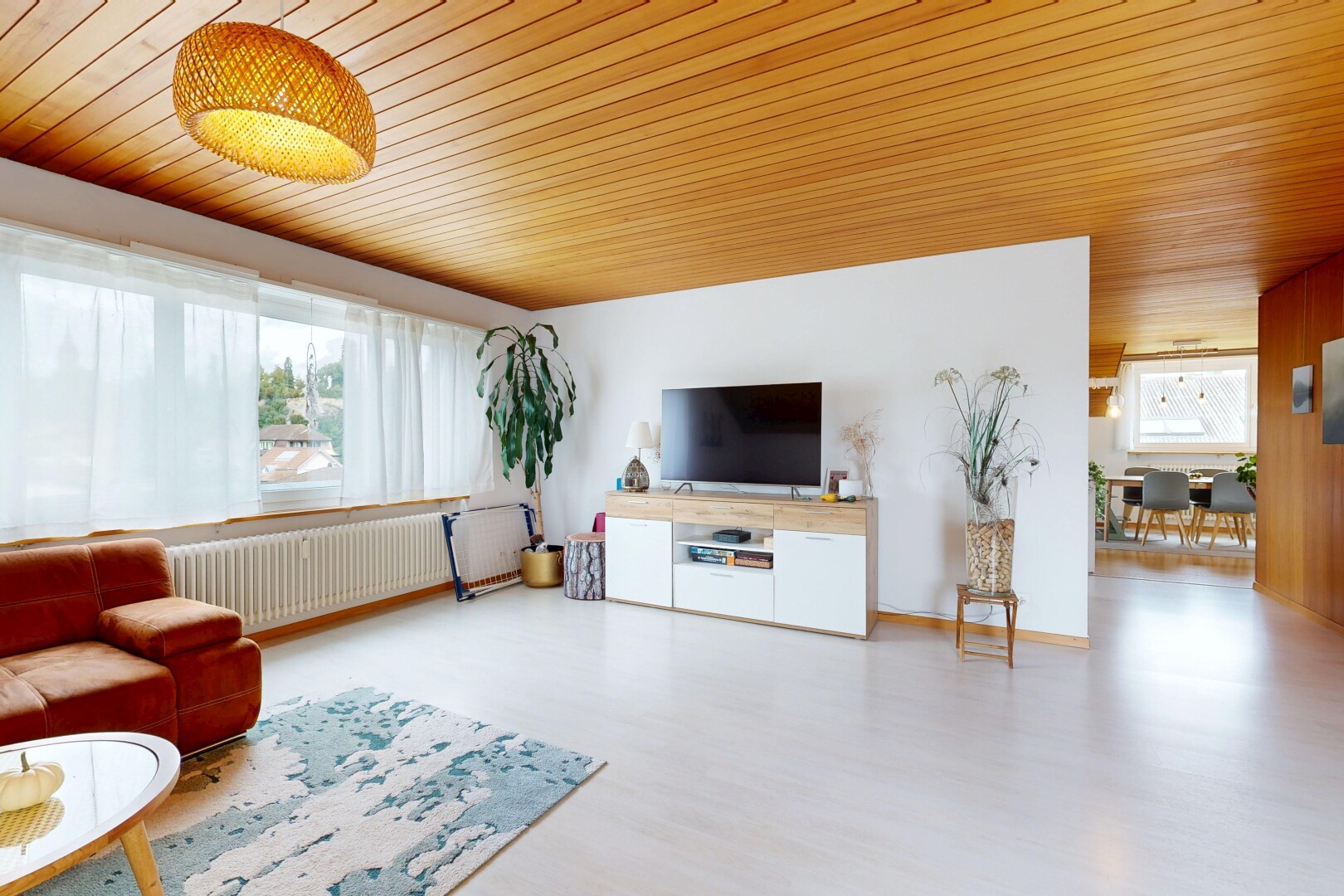 living area featuring radiator heating unit, wood ceiling, and wood finished floors