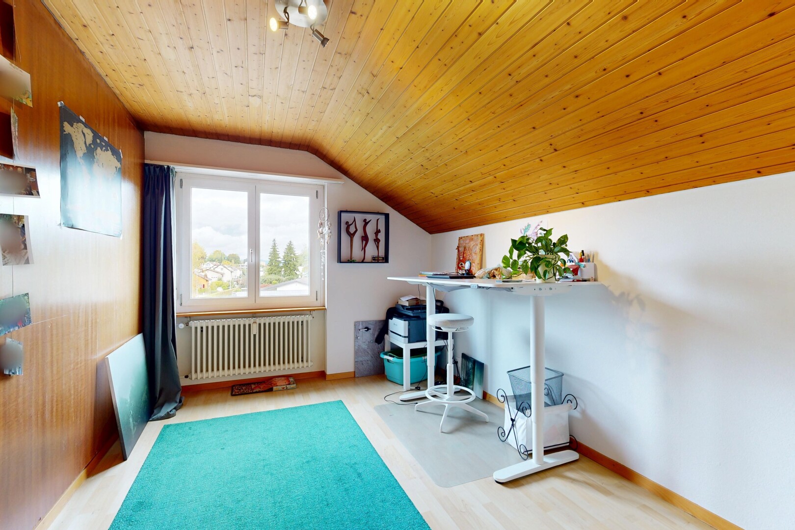 office area with light wood-style floors, radiator heating unit, and lofted ceiling