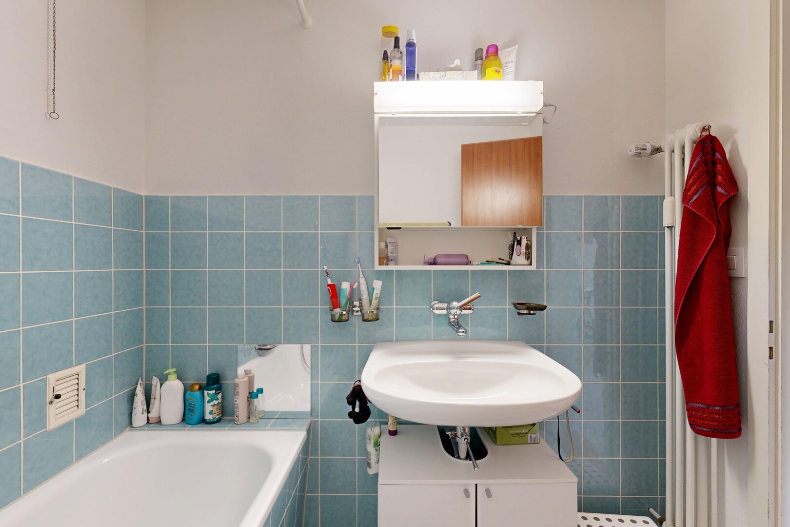 full bathroom featuring tile walls, a garden tub, and wainscoting