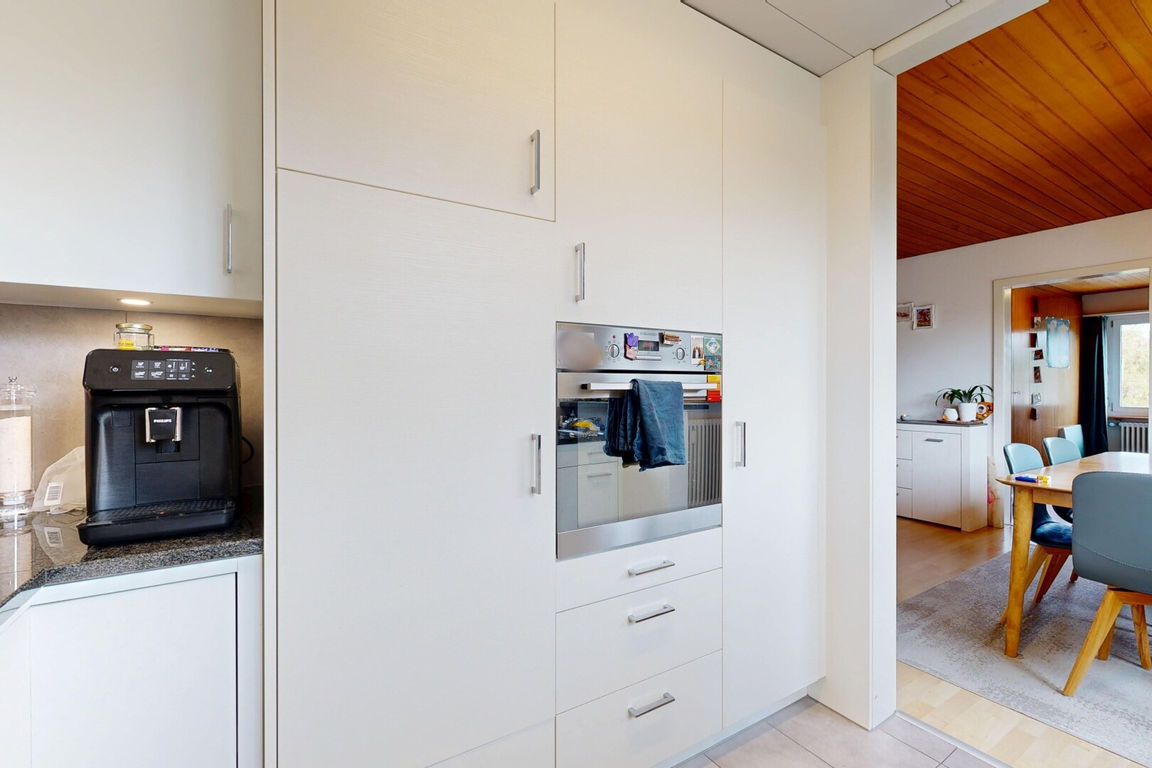 kitchen featuring white cabinetry, oven, light tile patterned floors, and wood ceiling