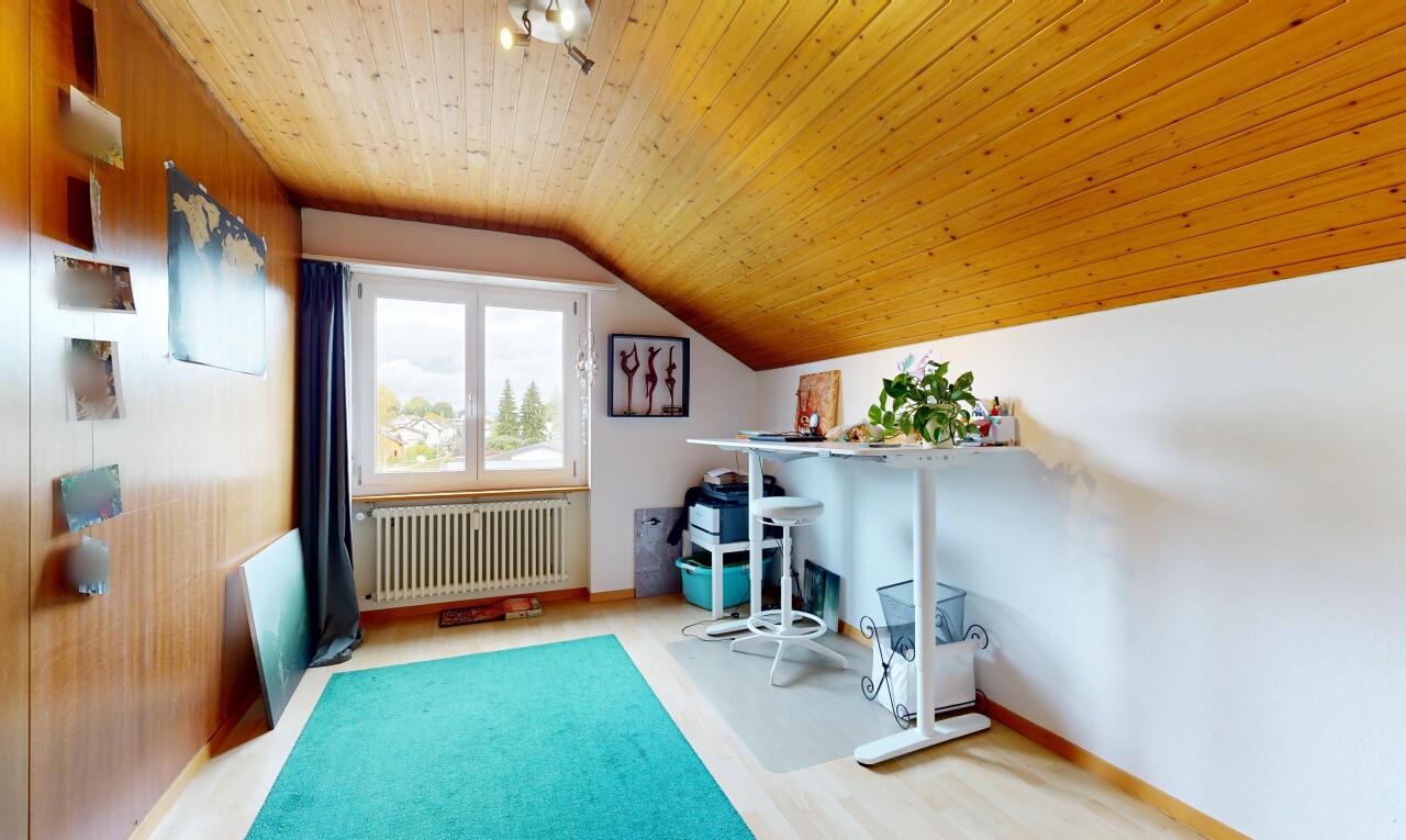 office area with light wood-style floors, radiator heating unit, and lofted ceiling