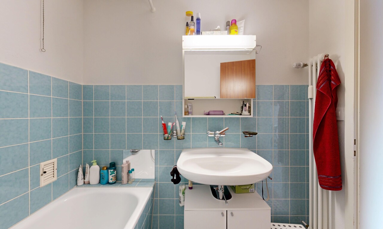 full bathroom featuring tile walls, a garden tub, and wainscoting