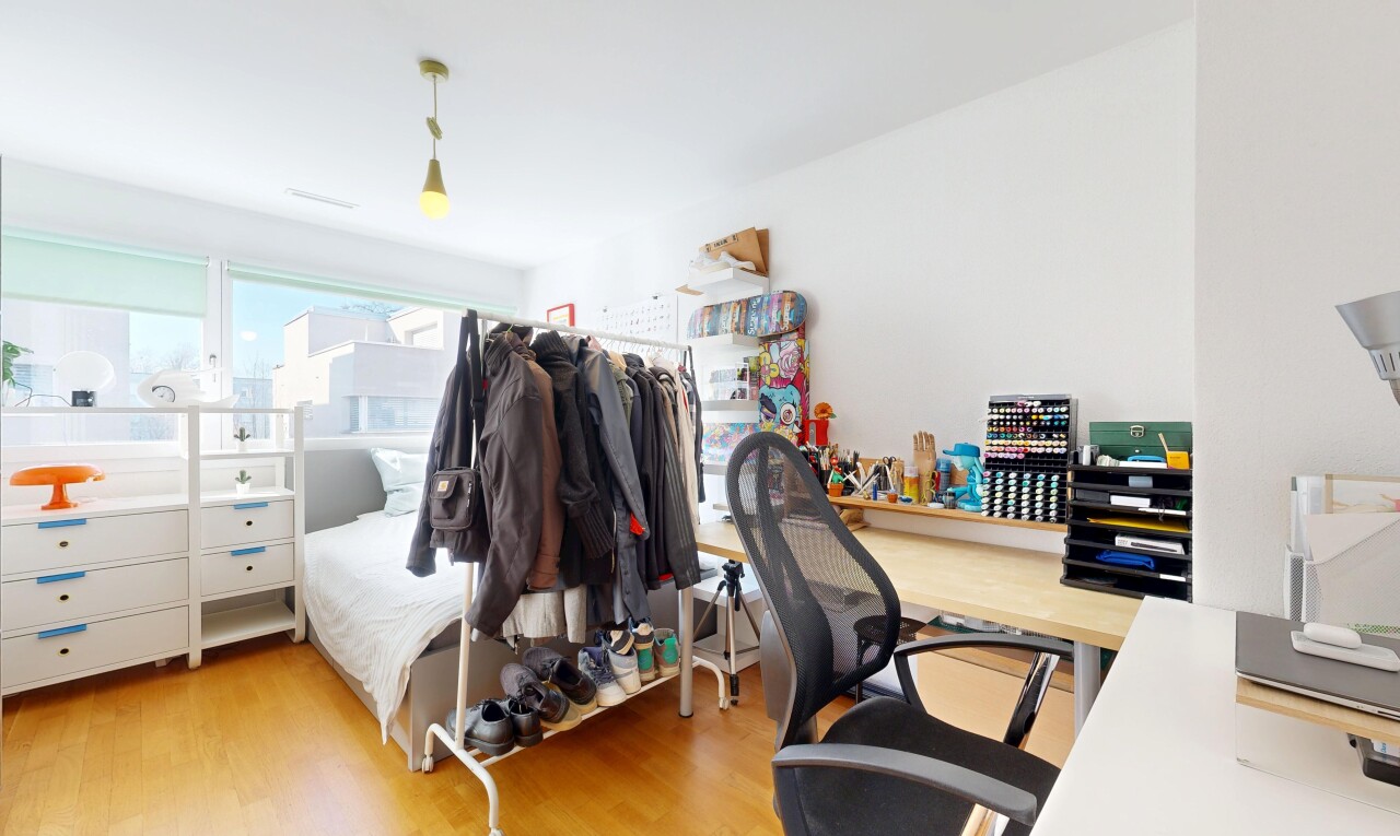 chambre avec sol en finition bois, wood finish floor, inside property, espace bureau, et lumière naturelle