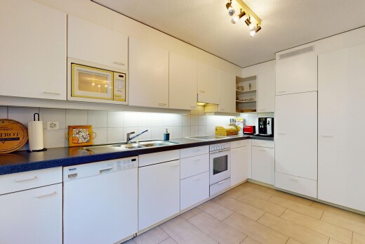 kitchen featuring open shelves, white appliances, dark countertops, and tasteful backsplash
