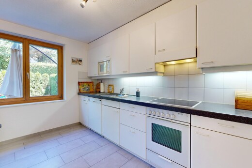 kitchen featuring white appliances, decorative backsplash, dark countertops, and white cabinets