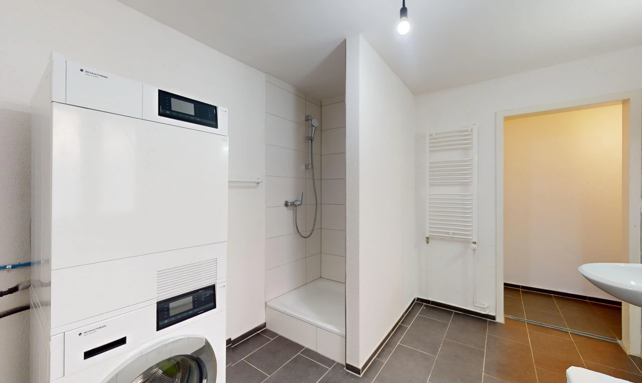 salle de bains avec radiateur, carrelage, et douche