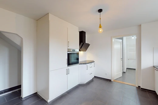 kitchen with white cabinetry, wall chimney exhaust hood, pendant lighting, and oven